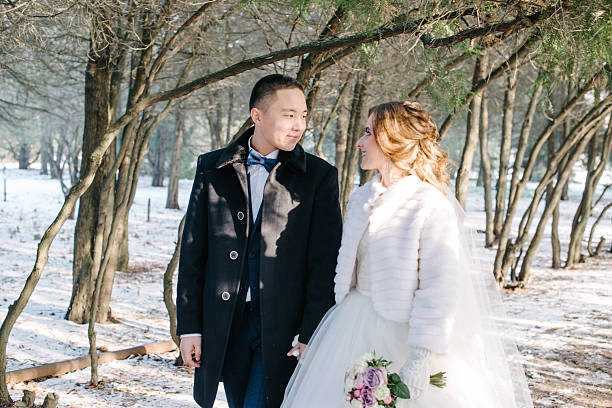 istock The bride and groom are walking through the winter forest 2246109766