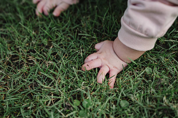 istock Curious baby crawling on grass outdoors 2246114978