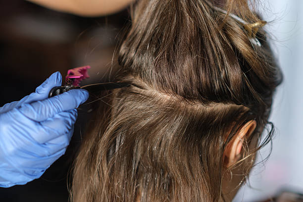 istock Creative Hair Coloring Process With Vibrant Hues at a Salon During Daylight Hours 2246116232