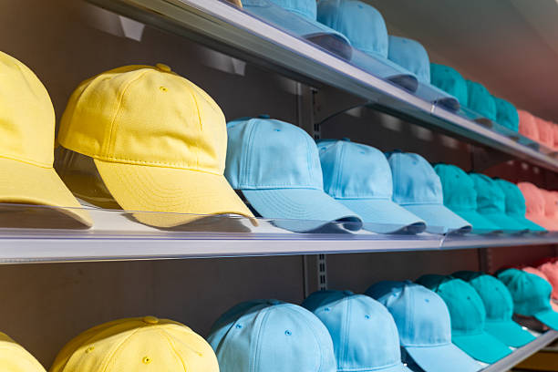 istock Colorful baseball caps neatly arranged on store shelves in rows. 2246116428