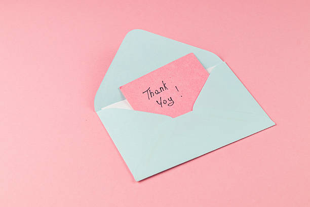 istock Thoughtful thank you note in an envelope on a pink background 2246118592