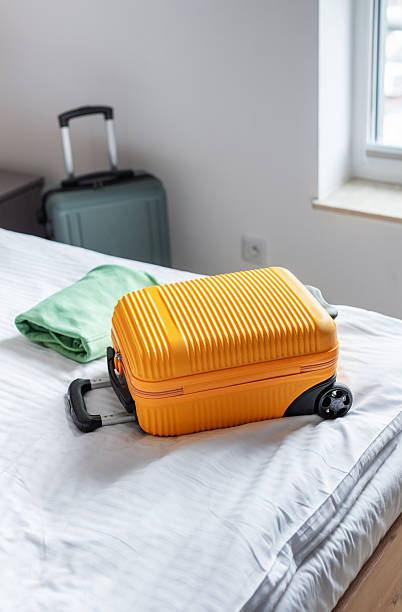 istock Travel suitcase on hotel bed preparing for journey 2246118660