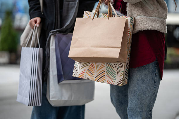 istock Women carrying multiple shopping bags after purchase 2246119724