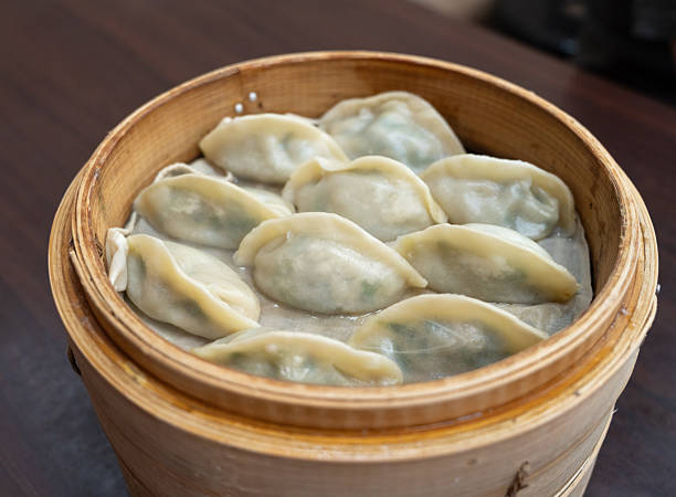 istock Steamed dumplings in bamboo steamer. 2246119773