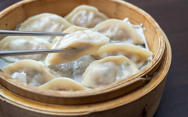 istock Steamed dumplings in bamboo steamer. 2246119806