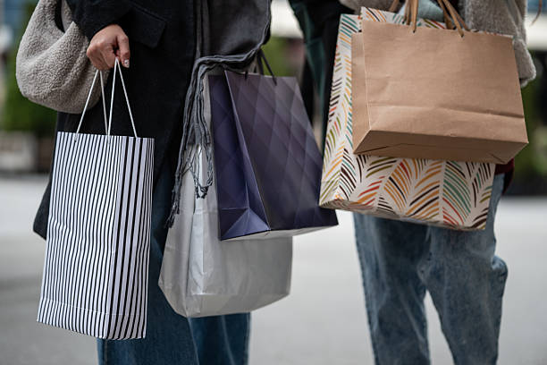 istock People carrying various shopping bags after store visit 2246120083
