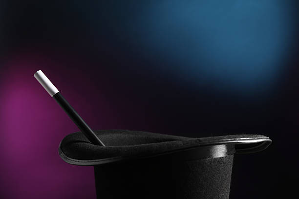 istock Magician's hat and wand on dark background, closeup 2246120382