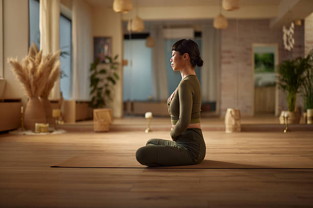 istock Asian woman doing breathing exercises in Yoga studio. 2246120929