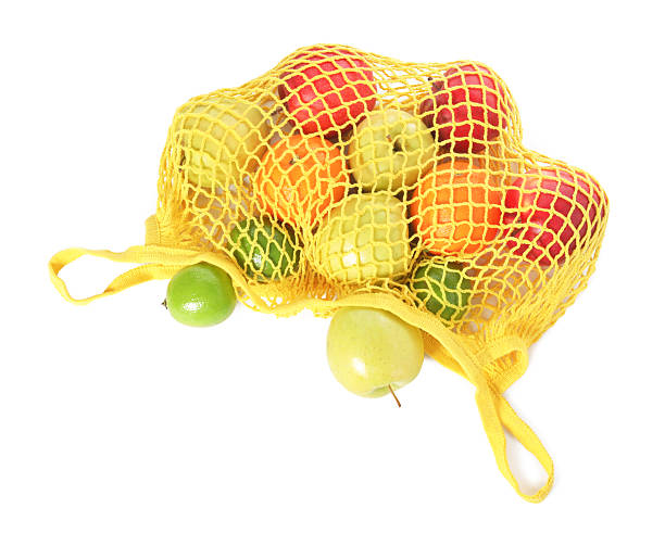 istock String bag with fresh fruits isolated on white, top view 2246121517