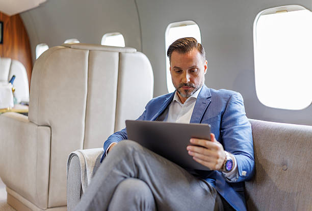 istock Businessman working on laptop during private jet flight 2246121518