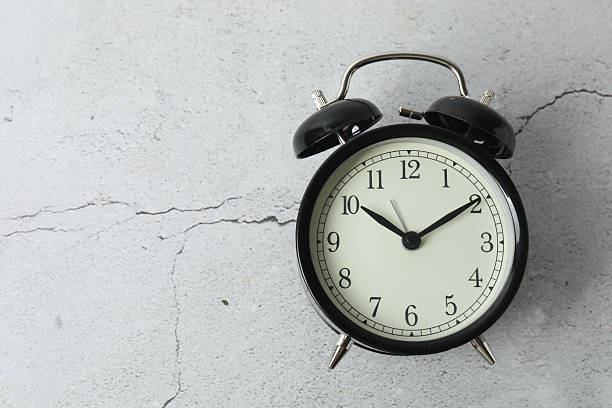 istock black alarm clock on backgrounds with space for text 2246122253
