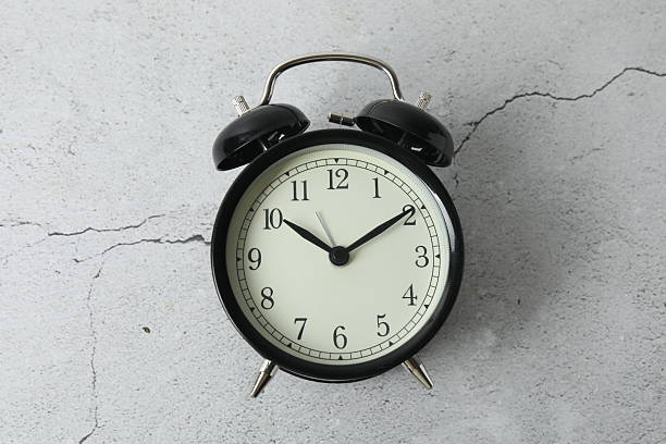 black alarm clock on backgrounds with space for text