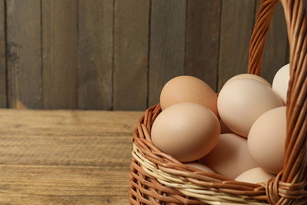 istock Chicken eggs in a basket placed on a wooden background 2246122423