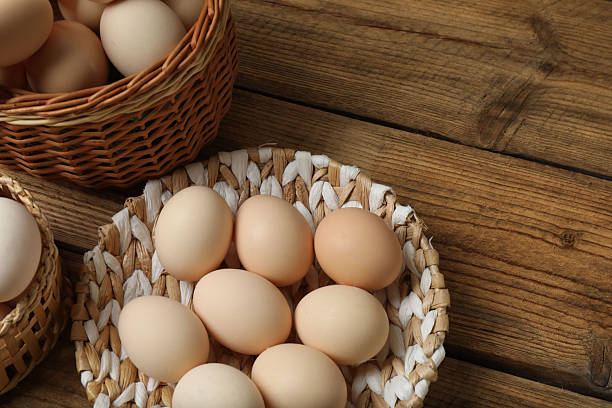 istock Chicken eggs in a basket placed on a wooden background 2246122456