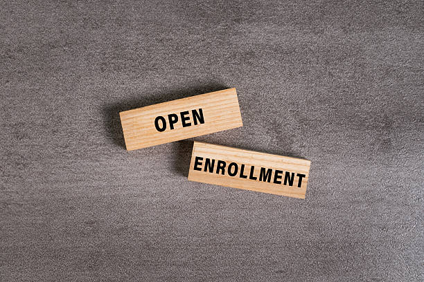 istock open enrollment words on wooden blocks isolated on cement background 2246122635
