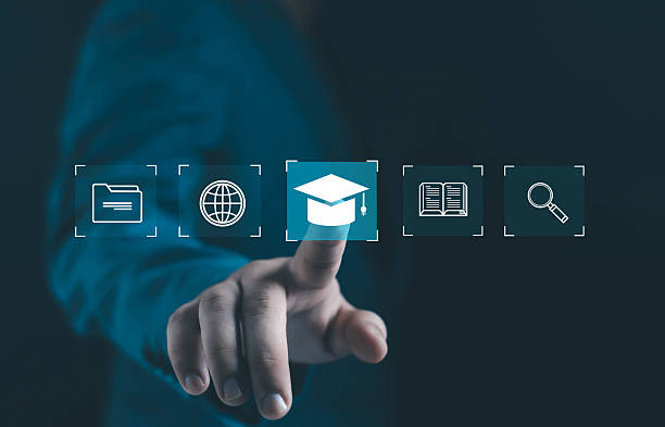 istock Businessman finger touching digital graduation cap icon among folder, globe, book, and search symbols, representing online education, e-learning, knowledge, and digital learning technology. 2246123499