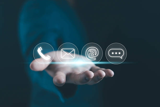 istock Businessman hand holding digital communication icons including phone, email, and chat, representing online contact, customer service, and corporate communication technology in modern business. 2246123541