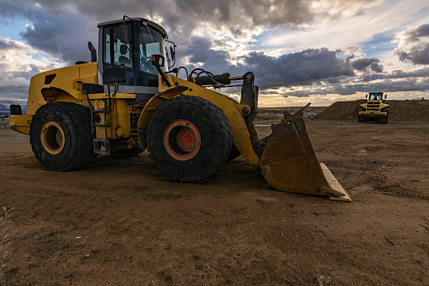 Excavator at the end of a working day at a construction site in a beautiful evening
