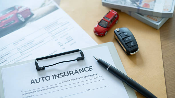 istock Car insurance document with pen and car key on desk, symbolizing financial transaction for vehicle purchase and protection plan. 2246125021