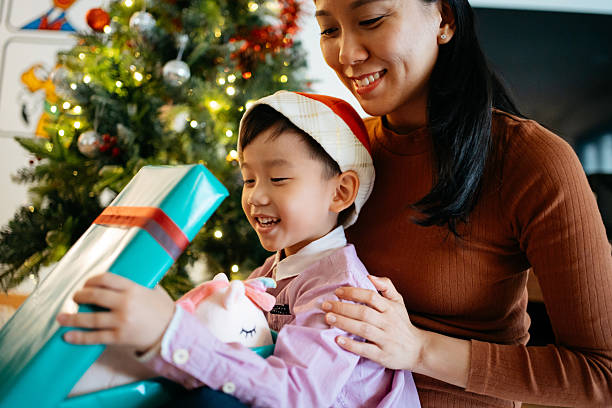 istock Mother and Son Opening Christmas Gift Together 2246125847