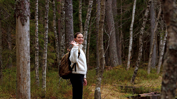 istock Young woman hikes in forest by lake 2246128709