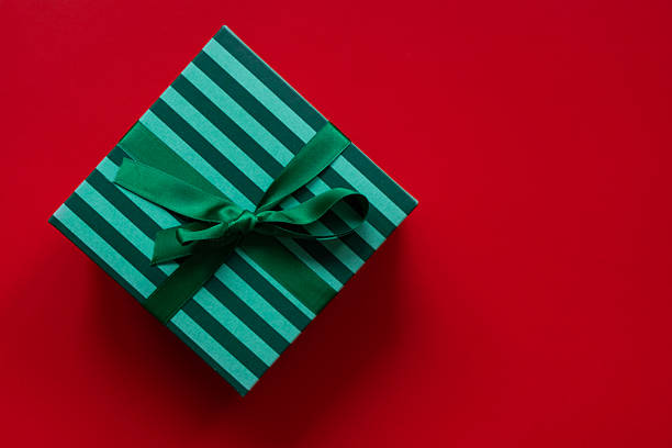 Christmas or birthday gift box on red background