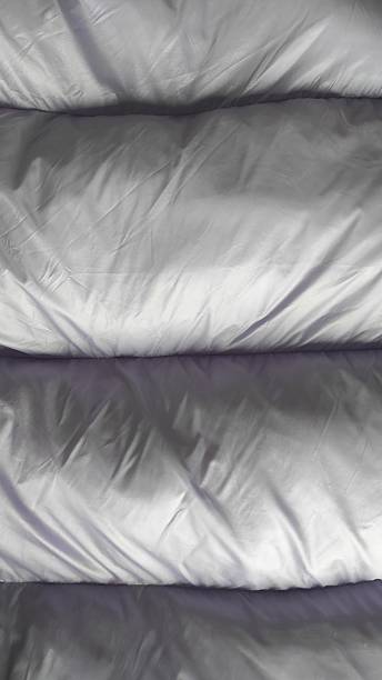istock Soft Gray Bedding Spread Across a Cozy Bed in a Warmly Lit Bedroom During a Quiet Evening 2246130071