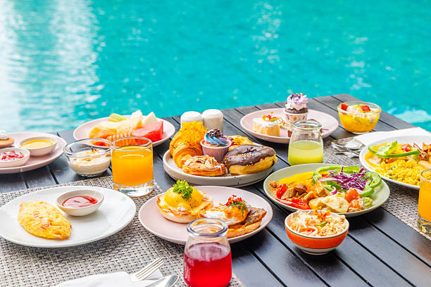 istock Vibrant breakfast spread on outdoor table by pool. Assorted pastries, 2246131713