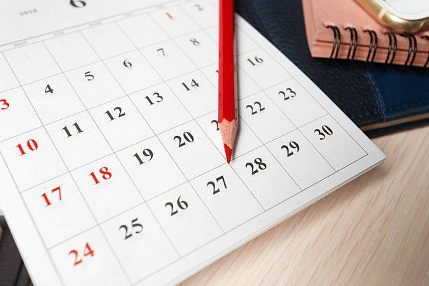 istock Calendar page marked with a red pencil for scheduling important dates in a workspace 2246132063