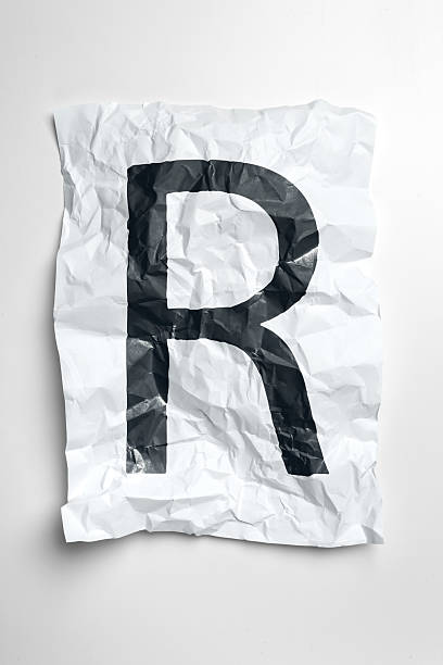 istock Crumpled paper with bold letter R displayed on a plain background 2246132741