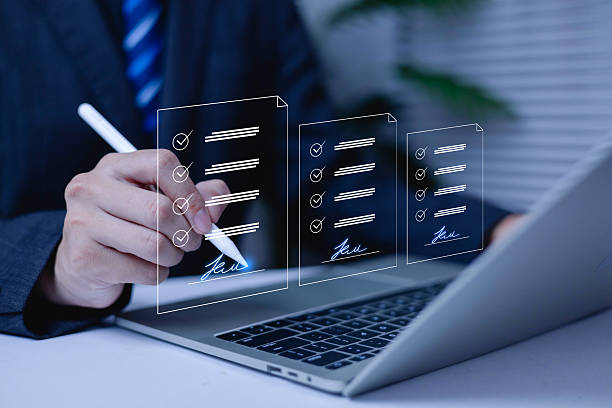 istock Businessman using digital pen to sign electronic documents on laptop with checklist interface. Concept of e-signature, online contract, digital approval, and paperless business workflow. 2246132797
