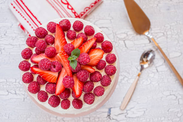 istock Cream chocolate cake with red berries and strawberries 2246133367