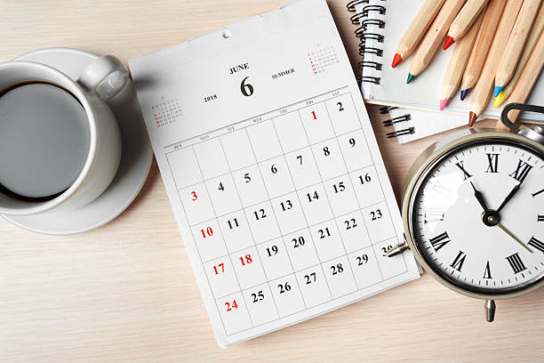 istock Desk setup featuring coffee, calendar, clock, and colored pencils in a productive workspace 2246133388