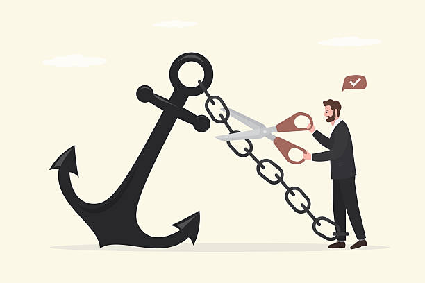 istock Confident businessman using scissors to cut chain tie himself with big heavy anchor. Freedom, relief or escape from bad habit, 2246135338