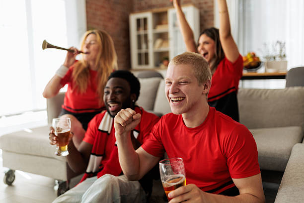 istock Friends Celebrating and Having Fun While Watching Sports Match 2246135523