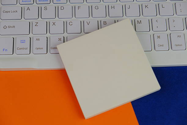 yellow sticky note with a pen on red background