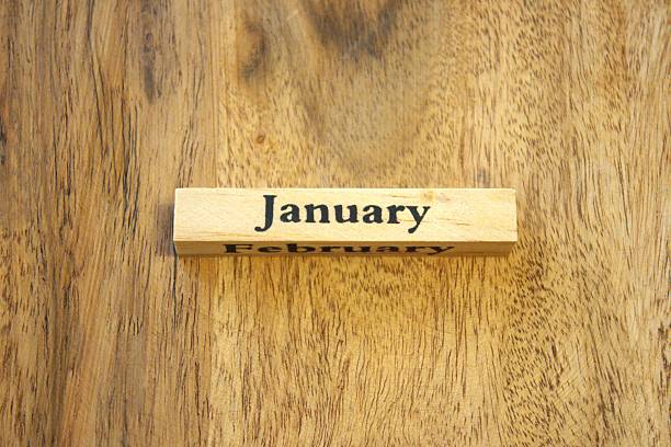 istock January text on wooden cube with wood background, close-up, Copy Space. 2246136292