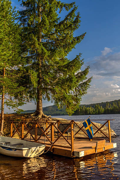 istock Swedish flag flying on a wooden lake dock 2246137406