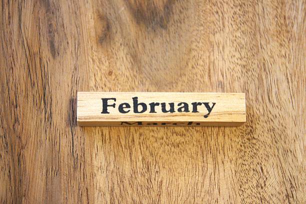istock February text on wooden cube with wood background, close-up, Copy Space. 2246137434