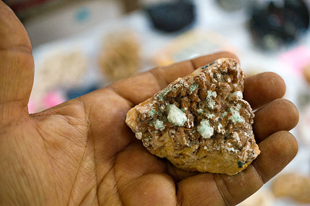 istock Hand holding a mineral specimen with crystals 2246139277