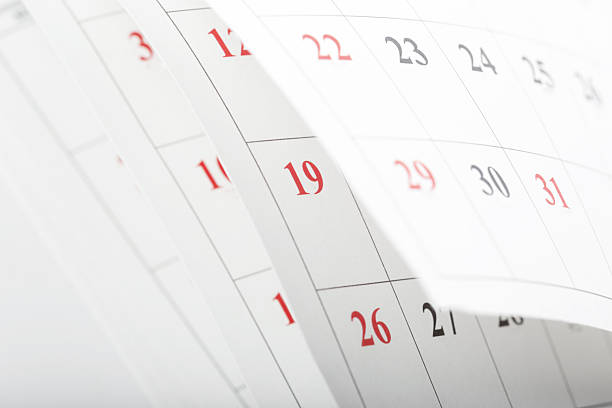 istock Calendars displaying dates with some numbers highlighted in red for important events 2246140005