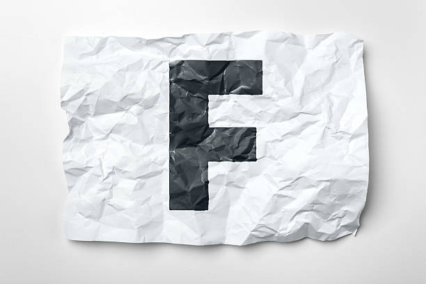 istock Crumpled paper with bold letter F displayed creatively on a neutral background 2246140007