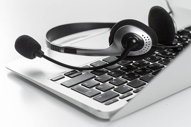 istock Headset resting on laptop keyboard during a virtual meeting setup at home office 2246140034