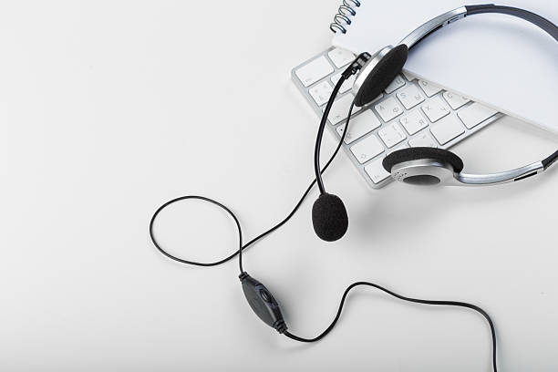 istock Headset and keyboard on a desk during remote work session in a quiet home office 2246140040