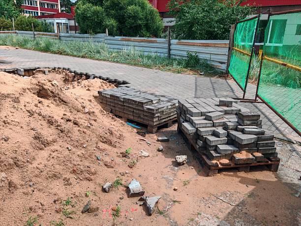 Unfinished Pavement with Exposed Sand and Displaced Bricks at Construction Site. sidewalk repair, paving stones in progress
