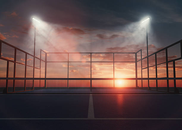 A single padel or pickleball court at dusk, illuminated by floodlights with a warm sunset glow, ideal for sports, fitness, and architectural design visuals - 3D render