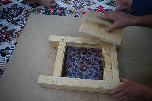 istock Pressing material in a wooden frame for crafting 2246143389