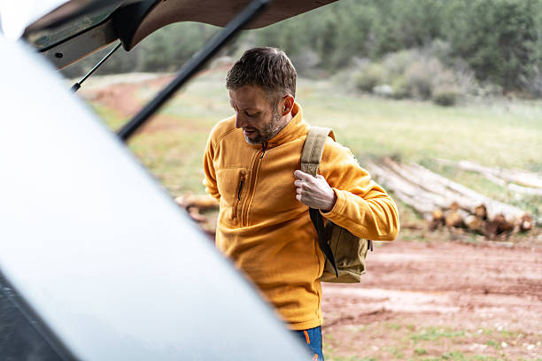 istock Man preparing for hike packing backpack in car trunk 2246148765