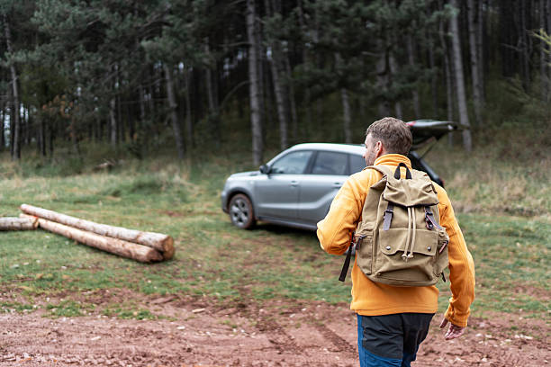 istock Man hiking to forest after parking suv 2246149489