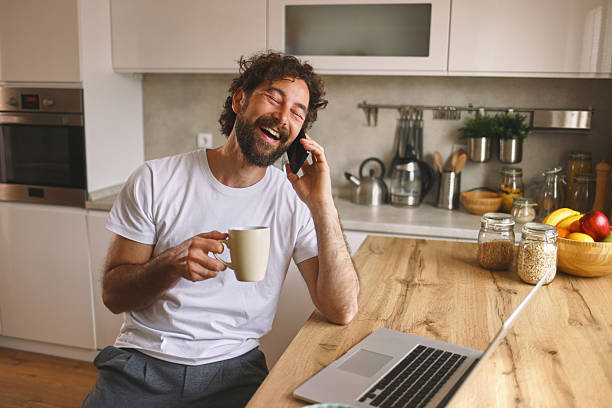 istock Cheerful man working remotely from home and drinking coffee 2246149578